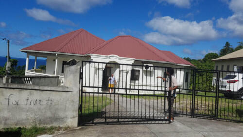 White Home with Iron Fence